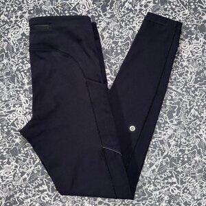 Black Lululemon leggings with mid-rise fit and side pockets